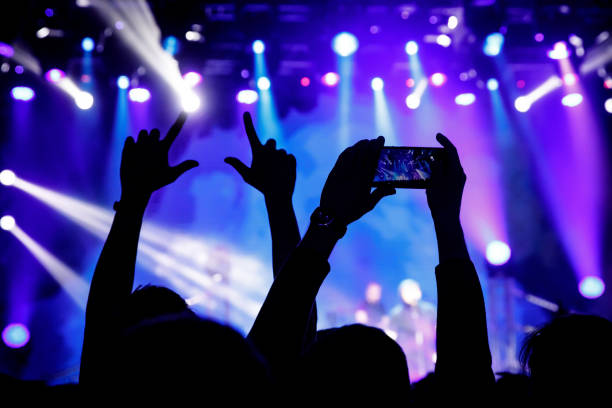 istock Filming a concert on mobile phone camera, 1141666316