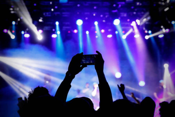 istock Filming a concert on mobile phone camera, 1141666322