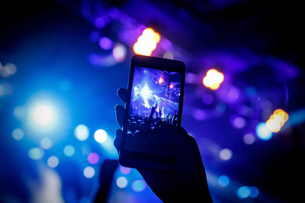 istock Filming a concert on mobile phone camera, 1141666326