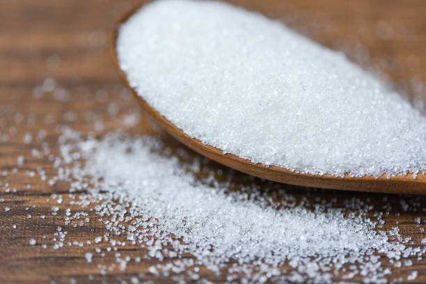 istock White sugar on wooden spoon and wood background 1141666391
