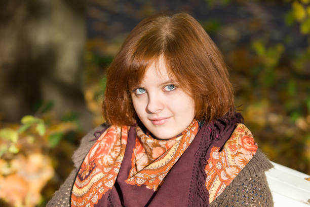 istock portrait on autumn bench 1141666497