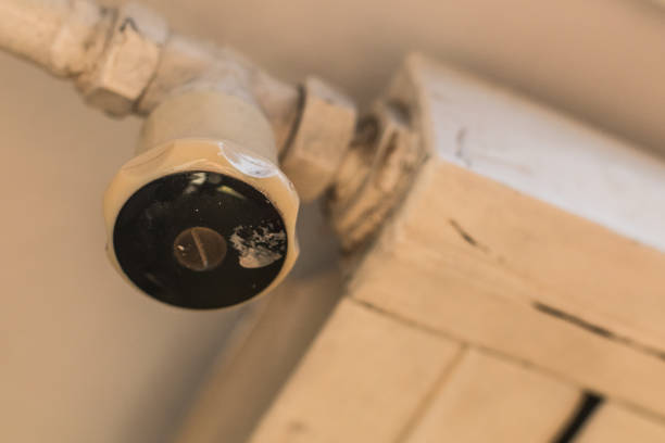 Old radiator heater valve and knob. Side view.