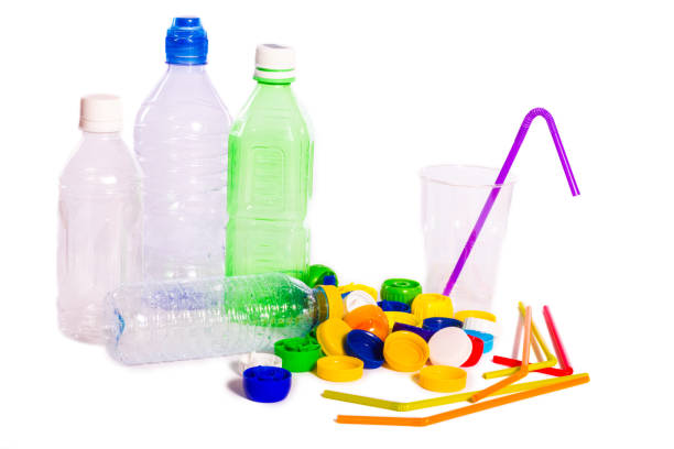 istock Plastic pollution. Plastic bottles, caps, straws and a glass isolated on white background 1141669772