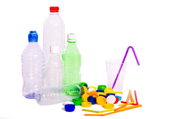 istock Plastic pollution. Plastic bottles, caps, straws and a glass isolated on white background 1141669784