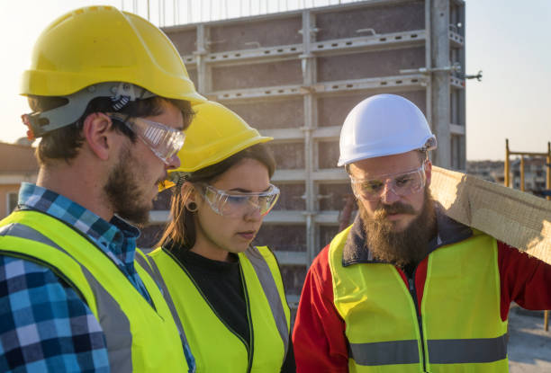 istock CU, Meeting of a Confident Female Architect, A Project Manager and a Construction Workers Discussing and Working Together at Construction site of a Residential Building on a Bright Sunny Day Using Architectural Drawings and a Digital Tablet 1141670114