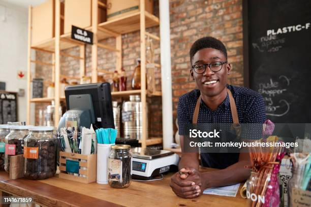 Portrait Of Male Owner Of Sustainable Plastic Free Grocery Store Behind Sales Desk Stock Photo - Download Image Now