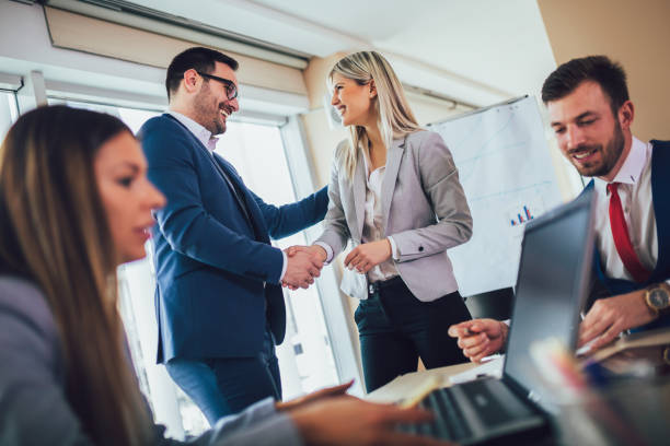 istock Businesspeople shaking hands in meeting room. Selective focus. 1141672439