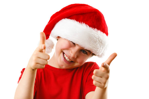 istock Christmas time - boy with Santa Clause hat 1141672514