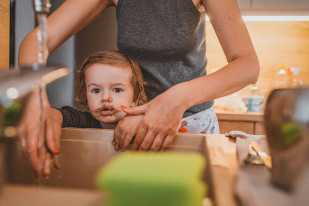 istock Little boy with down syndrome washing his hands 1141672871