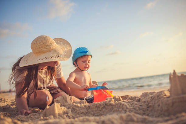 istock Mother and son on the beach playing with sand 1141673037