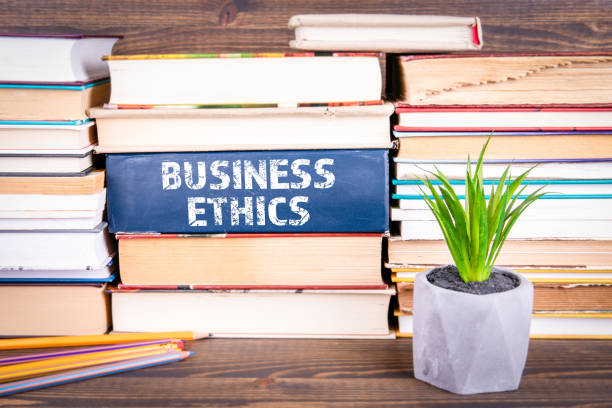 istock Business Ethics concept. Books stacked on table 1141673207
