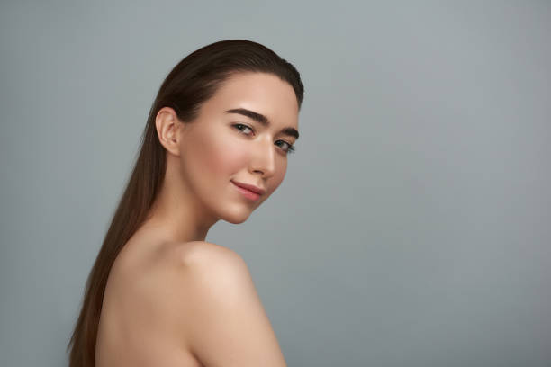 istock Serene young woman is against grey background 1141675161