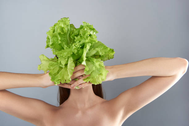 istock Woman with salad isolated on grey background 1141675211