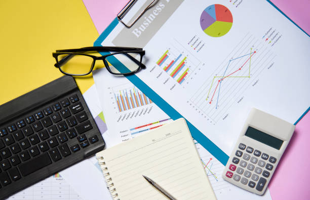 istock Financial and business graph chart report paper document with calculator open notebook paper 1141676398