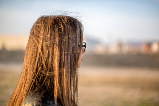 Hipster girl looking at sunset