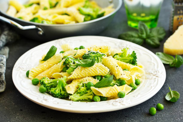 istock penne pasta with spinach pesto sauce, green peas and broccoli, top view 1141677190