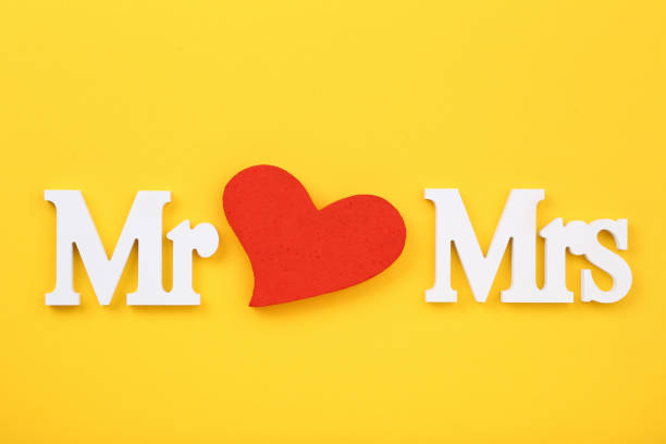 istock White letters Mr and Mrs with red heart on yellow background 1141678527