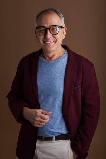istock Cheerful mature man posing for photo and looking relaxed 1141679730