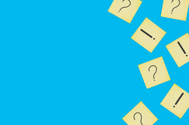 istock Scattered square paper sheets with handwritten question and exclamation marks on blue table. Top view. Business concept. Copy space 1141680160
