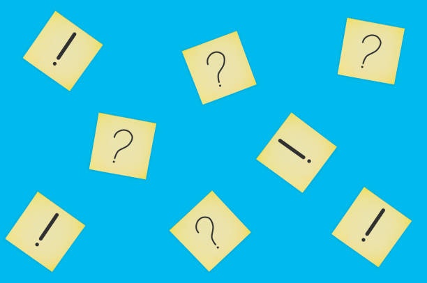 istock Scattered square paper sheets with handwritten question and exclamation marks on blue table. Top view. Business concept 1141680163