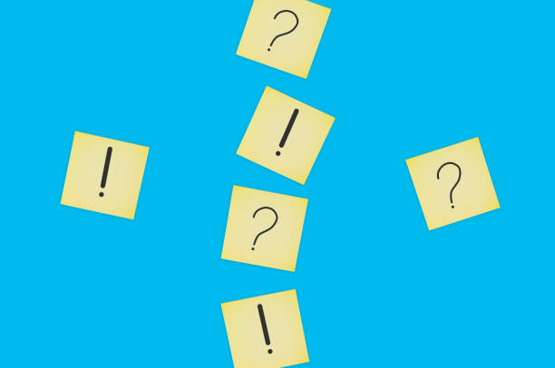 istock Scattered square paper sheets with handwritten question and exclamation marks on blue table. Top view. Business concept 1141680170