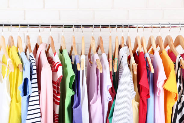 istock Fashion clothes hanging on brick wall background 1141680255