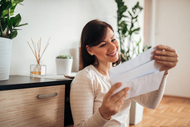 istock Beautiful woman looking at received mail. 1141680703