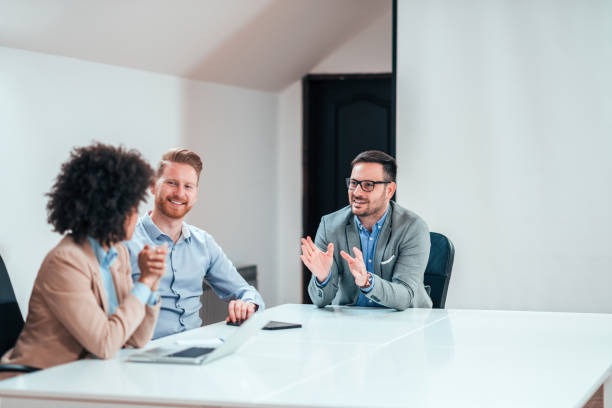 istock Smiling business partners talking in boardroom. 1141680729