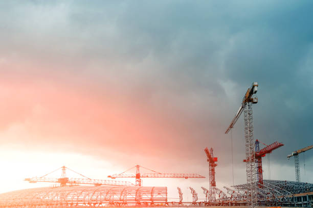 istock Construction site. Big industrial tower cranes with unfinished high raised buildings and blue sky in background. Scaffold. Modern civil engineering. Contemporary urban landscape. 1141681734