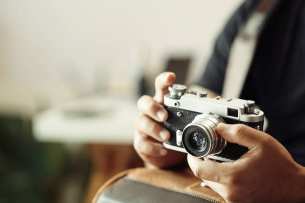 istock Photographer hands holding vintage camera 1141681884