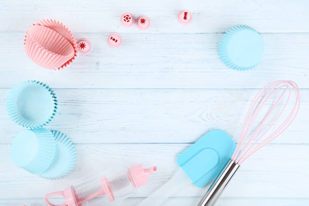 istock Cupcake cases with kitchen utensils on wooden table 1141684366