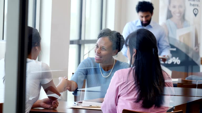 Female bank loan officer greets customers