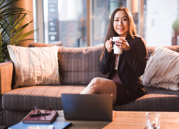 istock Young businesswoman drinking coffee and looking at camera. 1141686675