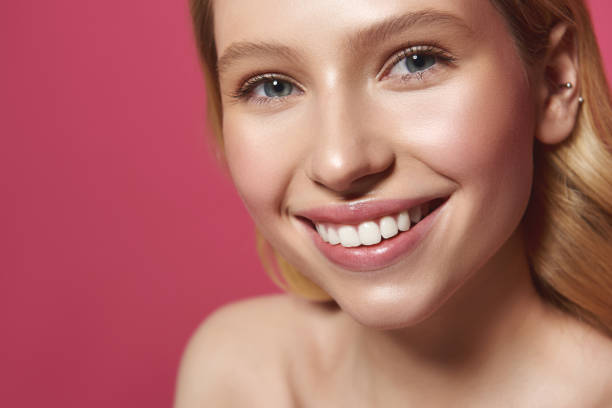 istock Sincerely smiling blonde woman isolated on pink 1141686796