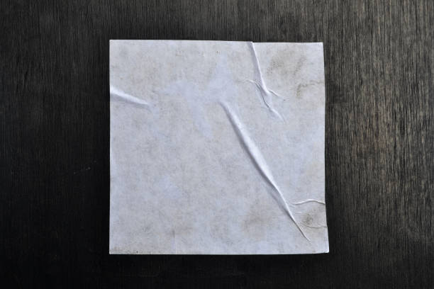 istock White sheet of paper on a black background. 1141686898