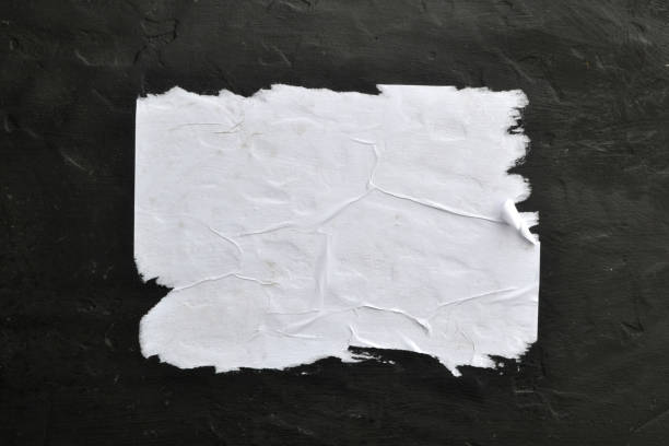 istock White sheet of paper on a black background. 1141686920