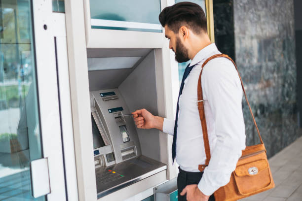istock Businessman using card at an ATM 1141687185