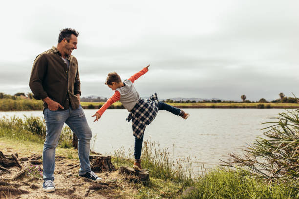 istock Father and son playing near the lake 1141687345
