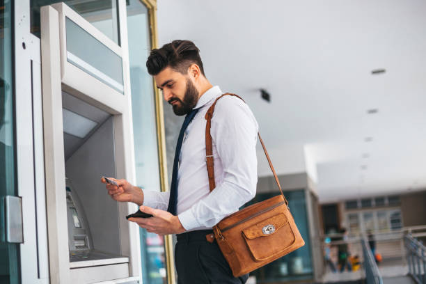 istock Businessman using card at an ATM 1141687356