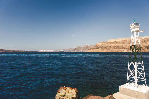 Small metal lighthouse in Athinios port, Santorini