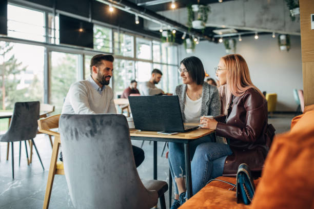istock Group of friends using laptop in cafe 1141688443