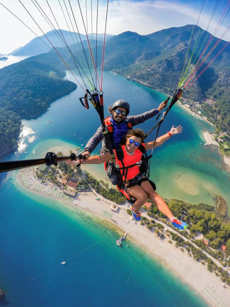 Tandem jump in paragliding. DCIM\100GOPRO\G0104802. Tandem jump in paragliding. aegean turkey photos stock pictures, royalty-free photos & images