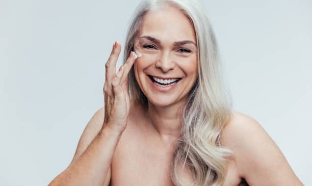 istock Woman applying anti aging cosmetic 1141688696