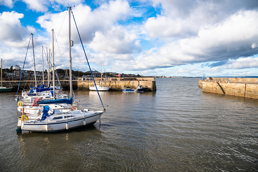 Sailing Boats Anchored in a Harbour under Blue Sky with Clouds on an Autumn Day. Musselburgh, Scotland, UK.