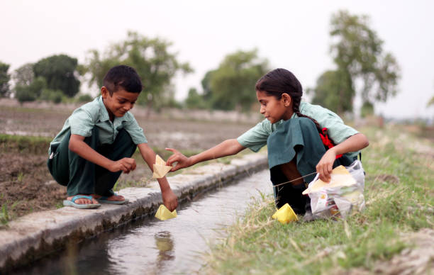 istock Flowing paper boat in to water 1141690663