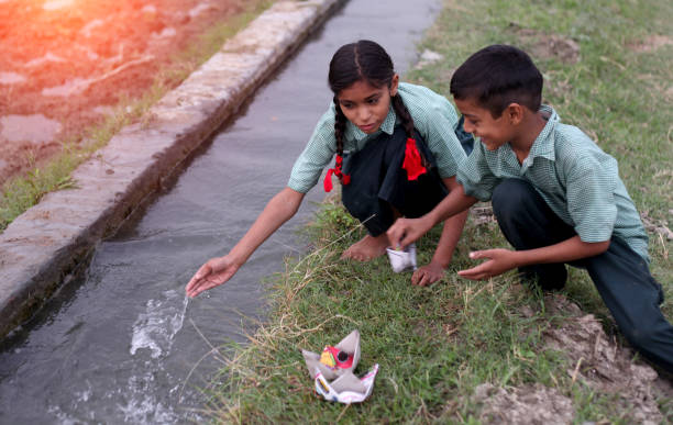 istock Flowing paper boat in to water 1141690681