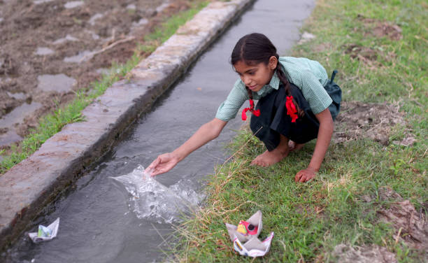 istock Flowing paper boat in to water 1141690684