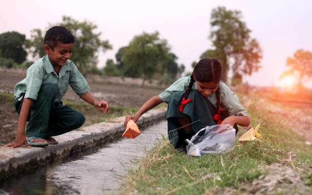 istock Flowing paper boat in to water 1141690685