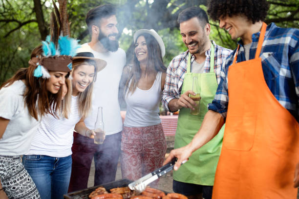 istock Friends making barbecue and having lunch in the nature 1141690852