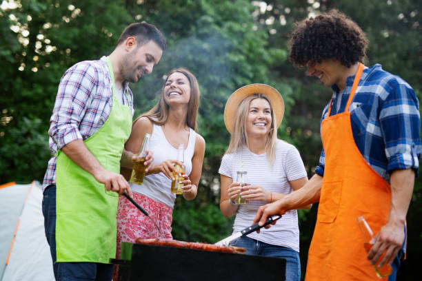 istock Friends having a barbecue party in nature while having fun 1141690925